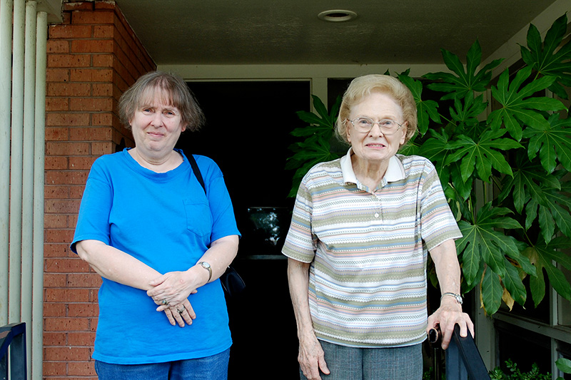 Mimi and Dona standing on the porch